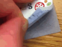 A Person Is Holding A Piece Of Paper With A Snowflake On It GIF