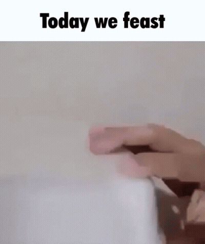 A Person Is Holding A Piece Of Paper With The Words `` Today We Feast '' Written Above It . GIF