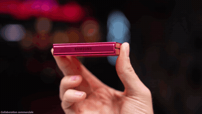 A Person Is Holding A Pink Samsung Device In Their Hand GIF