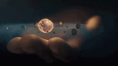 A Person Is Holding A Planet In Their Hand Surrounded By Planets GIF