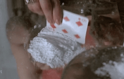 A Person Is Holding A Playing Card That Says ' G ' On It GIF