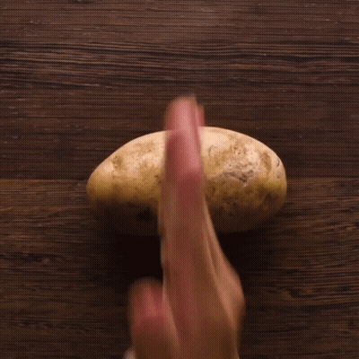 A Person Is Holding A Potato With Their Fingers GIF