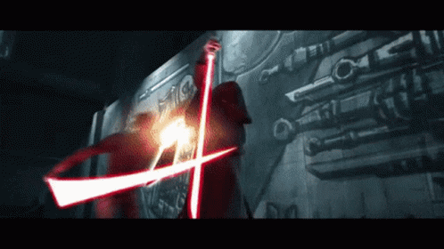 A Person Is Holding A Red Light Saber In Their Hand GIF