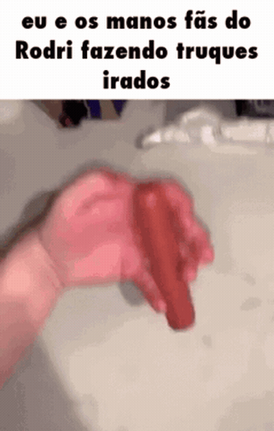 A Person Is Holding A Red Object In Their Hand In Front Of A Sink . GIF