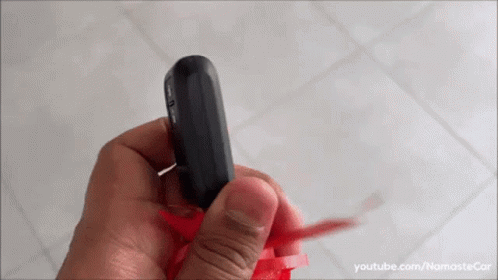 A Person Is Holding A Remote Control In Their Hand And The Video Is On Youtube.com/namastecar GIF
