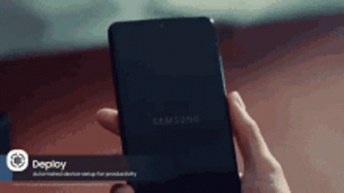 A Person Is Holding A Samsung Phone In Their Hands GIF