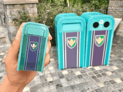 A Person Is Holding A Small Blue Trash Can With A Shield On It GIF