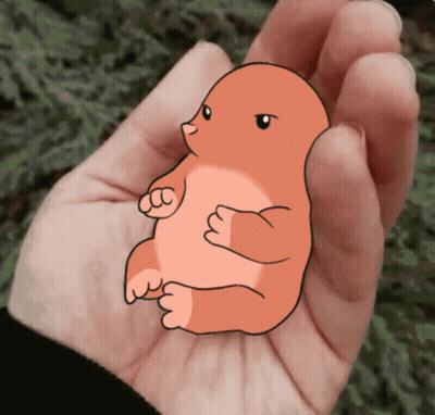 A Person Is Holding A Small Cartoon Animal In Their Palm GIF
