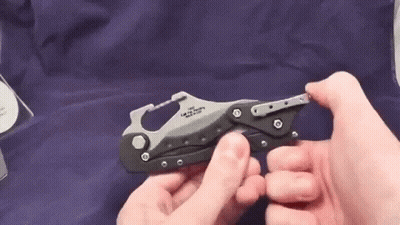A Person Is Holding A Small Knife In Their Hands . GIF