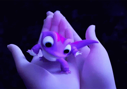A Person Is Holding A Small Purple Lizard In Their Hand GIF