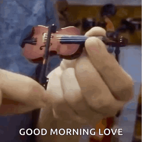 A Person Is Holding A Small Violin With The Words Good Morning Love Below It GIF