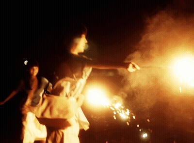 A Person Is Holding A Sparkler In Their Hand In The Dark GIF