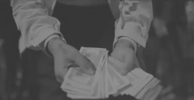 A Person Is Holding A Stack Of Money In Their Hands . GIF