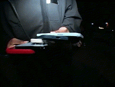 A Person Is Holding A Stapler And A Cell Phone GIF