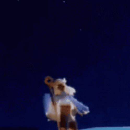 A Person Is Holding A Stick In Front Of A Fireworks Display . GIF