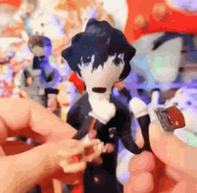 A Person Is Holding A Stuffed Animal In Their Hand In Front Of A Bunch Of Stuffed Animals . GIF