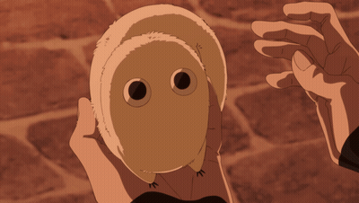A Person Is Holding A Stuffed Animal With A Face On It GIF