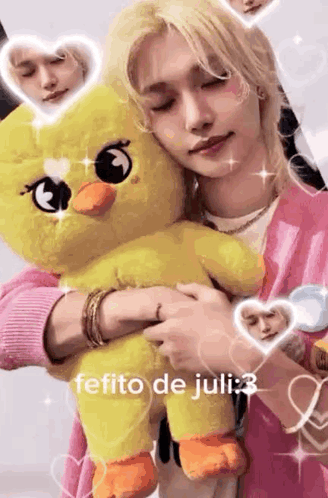 A Person Is Holding A Stuffed Duck In Their Arms . GIF