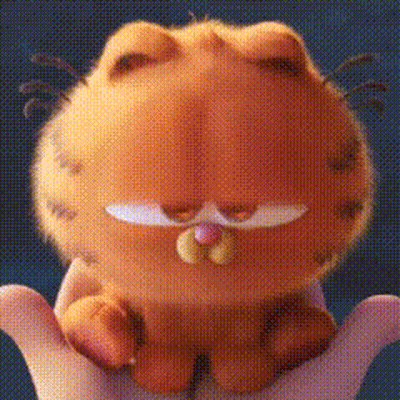 A Person Is Holding A Stuffed Garfield Cat In Their Hands . GIF