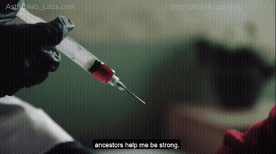 A Person Is Holding A Syringe That Says Ancestors Help Me Be Strong On It GIF