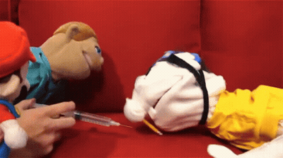 A Person Is Holding A Syringe To A Stuffed Animal GIF