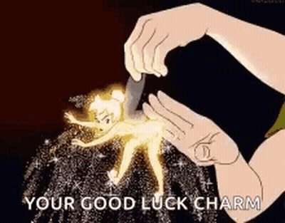 A Person Is Holding A Tinkerbell Figurine With A Knife And Saying `` Your Good Luck Charm '' . GIF