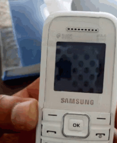 A Person Is Holding A White Samsung Phone GIF