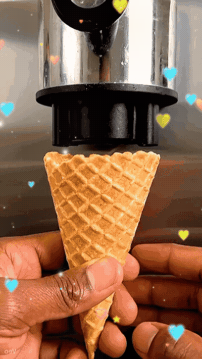 A Person Is Holding An Ice Cream Cone With Hearts Flying Around It GIF