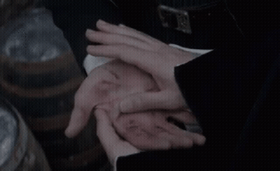 A Person Is Holding Another Person 'S Hand With A Wound In It . GIF