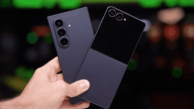 A Person Is Holding Two Cell Phones One Of Which Is A Samsung Flip Phone GIF