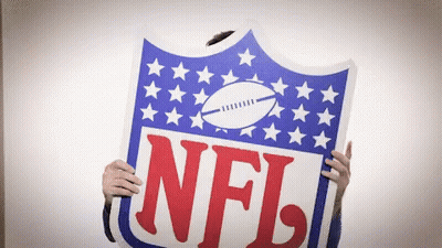 A Person Is Holding Up A Sign That Says NFL On It GIF