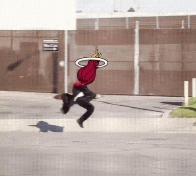 A Person Is Jumping In The Air With A Basketball In The Air GIF