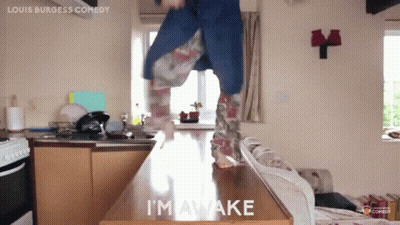 A Person Is Jumping On A Counter With The Words I 'M Awake On It GIF