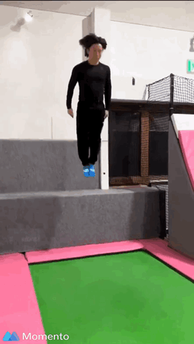 A Person Is Jumping On A Green And Pink Trampoline With The Word Momento In The Corner GIF