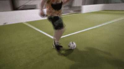 A Person Is Kicking A Soccer Ball On A Field GIF