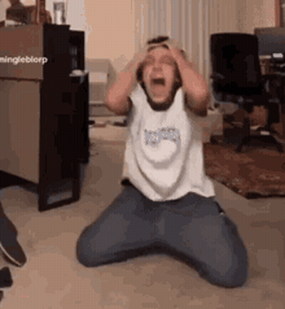A Person Is Kneeling Down With Their Hands On Their Head . GIF