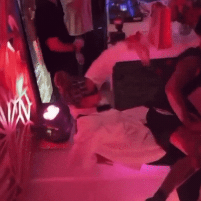A Person Is Laying On A Bed In A Room With Purple Lights And A Sign That Says Vin GIF