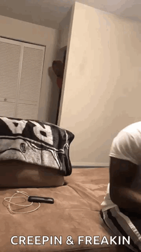 A Person Is Laying On A Bed With The Words Creepin & Freakin Written On The Bottom . GIF