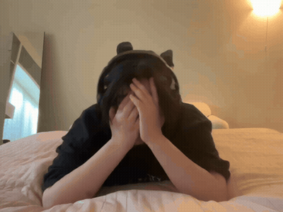 A Person Is Laying On A Bed With Their Hands On Their Face GIF