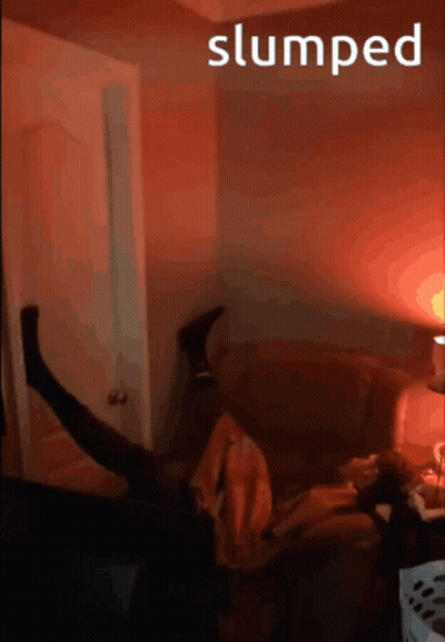 A Person Is Laying On A Couch With The Word Slumped Behind Them GIF