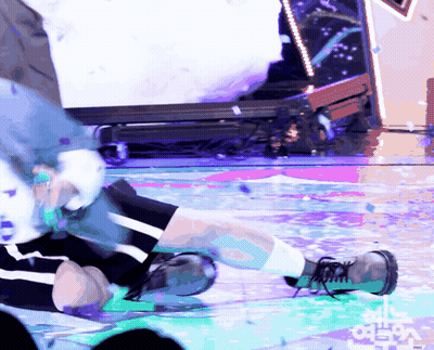 A Person Is Laying On A Stage With A Sign That Says ' Mbc ' On It GIF