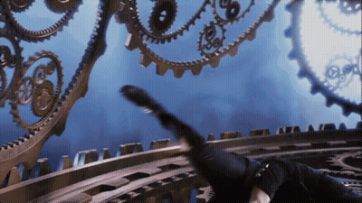 A Person Is Laying On A Staircase With Gears Behind Them GIF