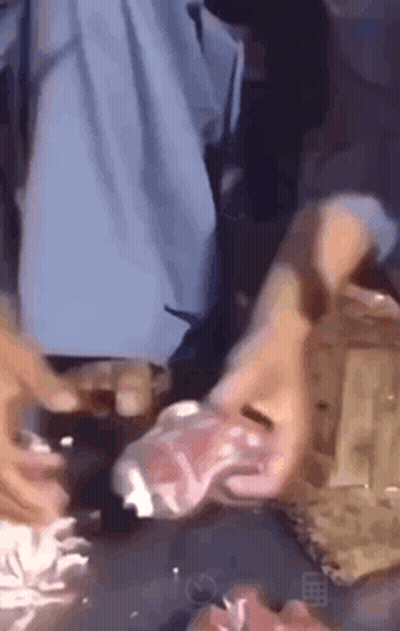 A Person Is Laying On A Table With A Plastic Bag On Their Face . GIF