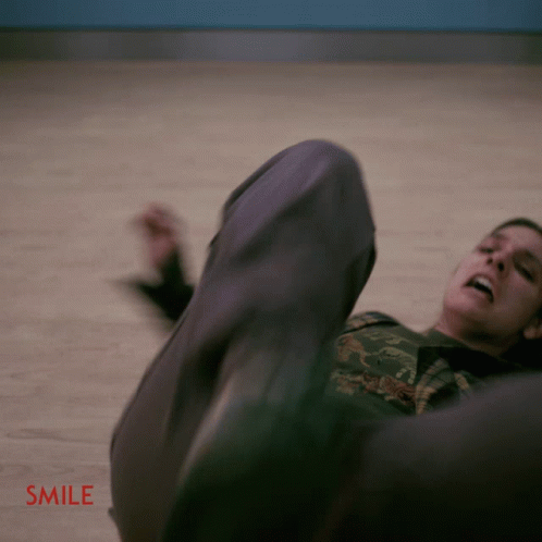A Person Is Laying On The Floor And The Word Smile Is On The Bottom Right GIF