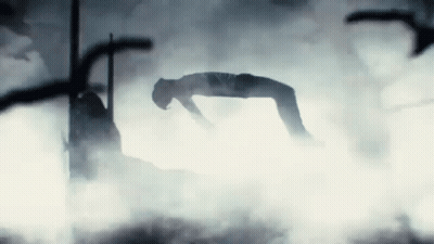 A Person Is Laying On Their Back In A Foggy Room GIF