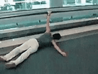 A Person Is Laying On Their Back On The Floor With Their Arms Outstretched . GIF