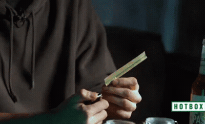 A Person Is Lighting A Cigarette With A Hotbox Logo In The Corner GIF