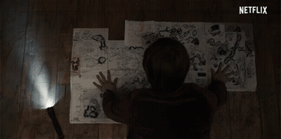 A Person Is Looking At A Map With A Netflix Logo Behind Them GIF