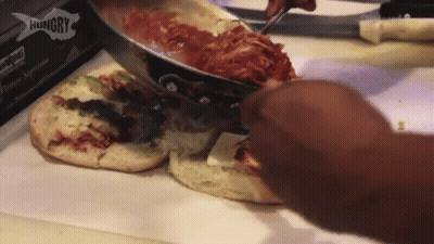 A Person Is Making A Pizza With A Hungry Box Behind Them GIF