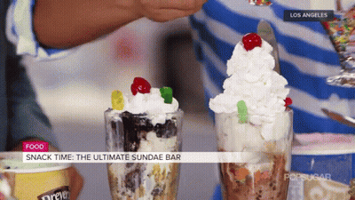 A Person Is Making A Sundae With Gummy Bears On Top GIF